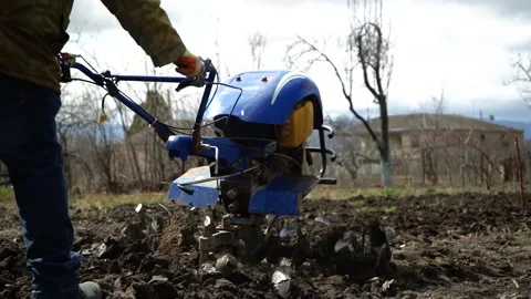 A man is plowing the land with a tractor Stock Footage 151595918