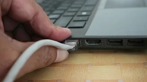 Man Plug In the Network Cable to the laptop. Connect to the internet Stock Footage 196803381