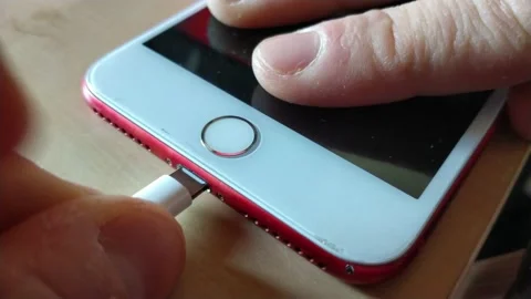 Man plug white charge cable at the iphone. phone battery charge. 스톡 동영상 232988362