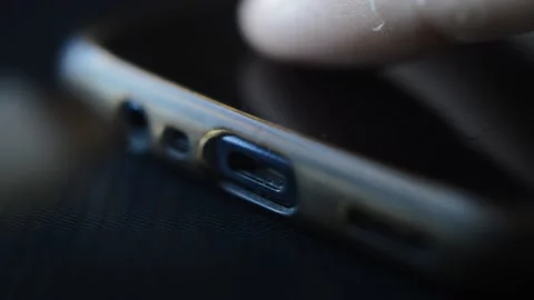 Man plug a white charger cable at his phone. phone battery charger Video stock 202082968