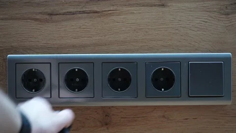 Man plugging and unplugging a wall charger. Stock Footage 220189642
