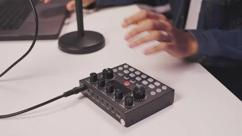 Man plugging audio cable into sound mixer for podcast or livestream setup Stock Footage 310153272