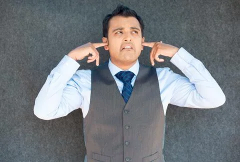 Man plugging ears for loud noise Stock Photos