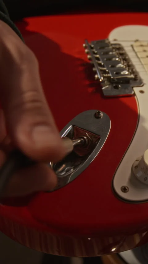 Man Plugging Instrument Cable into Electric Guitar for Recording Stock Footage 337544763