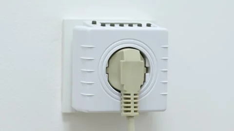 Man plugging socket computer timer with some electronic appliance Stock Footage 255209176
