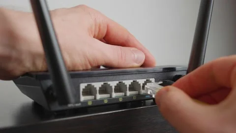 Man plugging in a WiFi router. Close up Stock Footage 221031135