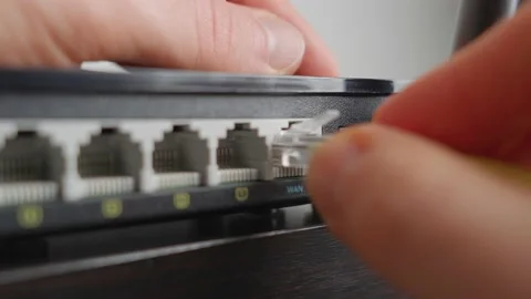 Man plugging in a WiFi router. Extreme close up Stock Footage 220939888