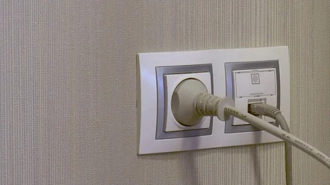 Man plugs a plug into the outlet Stock Footage 78307287