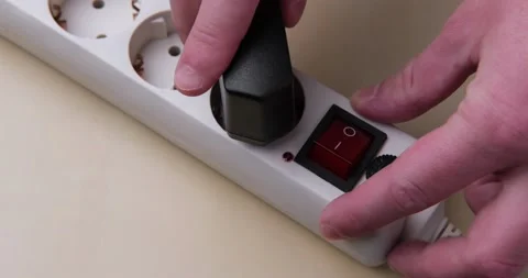 The man plugs two chargers into the socket. Stock Footage 142152018