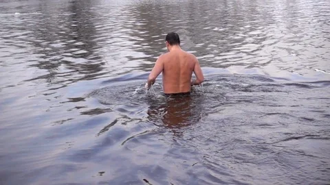 Man plunges into the river in winter in slow motion Stock Footage 84848243