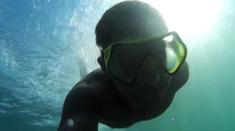Man plunges into the sea. Man swimming underwater. Stock Footage