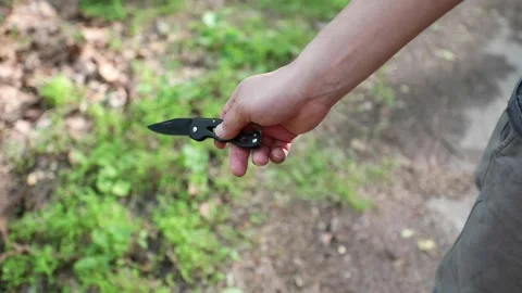 A man with a pocketknife Stock Footage 130932422