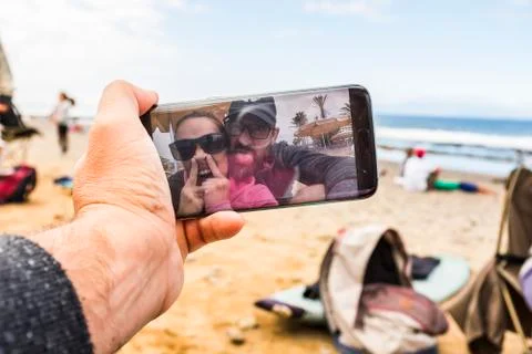 Man point of view of funny crazy couple having fun taking selfie or doing vid Stock Photos