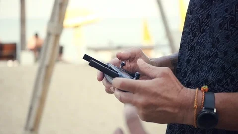 The man is pointing at the buttons on the drones control panel. HD, 1920x1080 Stock Footage 87913059