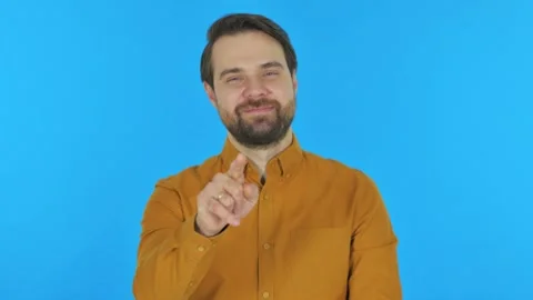 Man Pointing at Camera on Blue Background, Portrait Stock-Footage 297442610