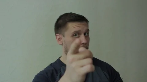 Man pointing at camera, winking and smiling. Video stock 77324783