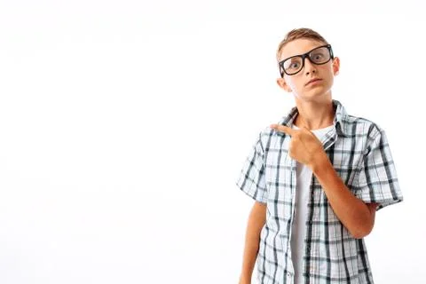 Man pointing at copy blank space, handsome young guy in Studio on white backg Stock Photos
