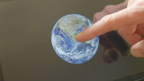 A man pointing at the earth on a screen Video stock 102952568