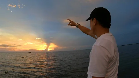 Man pointing finger to the sunset sky at Siem Reap Tonle Sap, Cambodia Stock Footage 108205643