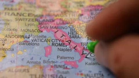 Man Pointing Green Pin on Rome Italy Location on Paper World Map Close Up Stock Footage 333577835