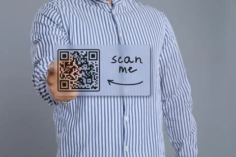 Man pointing at illustration of QR code on light grey background, closeup Foto stock
