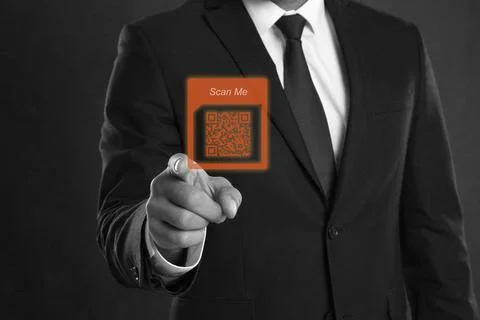 Man pointing at illustration of QR code on dark background, closeup Foto stock