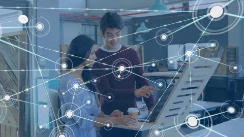 Man pointing at laptop as woman steadying, typing at desk causing analytics web Stockbeeldmateriaal 334184853