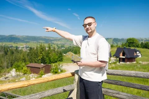 Man Pointing with Map in Hand in Scenic Mountain Countryside Stock Photos