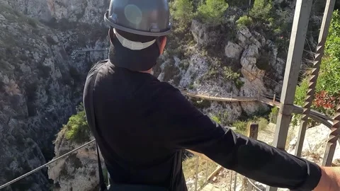 Man pointing at Relleu walkways from the start of the route Stock Footage 329002906
