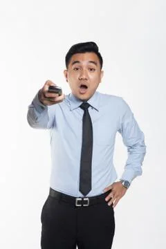 Man pointing remote control with sleepy expression Stock Photos