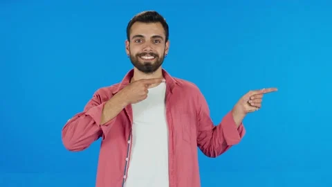 Man pointing to the right of the screen with her fingers on a blue background. Stock Footage 140539465