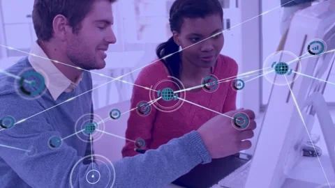 Man pointing at screen activating node HUD while woman leaning with stylus, 動画素材 334312745