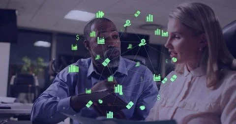 Man pointing sparking green data icons, woman reading papers, tapping tablet and Stock Photos