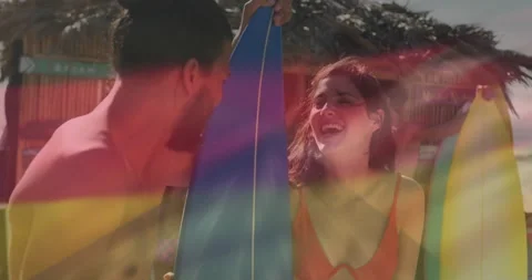 Man pointing surfboard design while stripes fading into star pattern inspiring Video stock 314527134