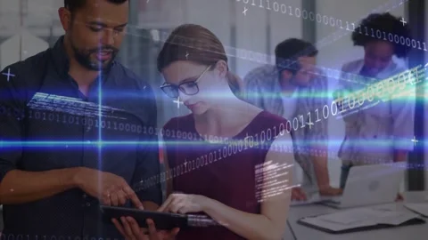 Man pointing tablet, woman editing in tech office updating project, code over Stock Footage 331276187