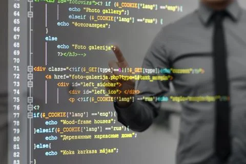 Man pointing on virtual screen with website programming code 库存照片