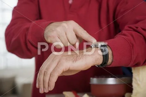 Man pointing on wristwatch Stock Photos