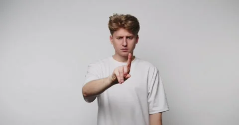 Man points and gestures with finger in studio location while expressing dif.. Stock-Footage 328248387