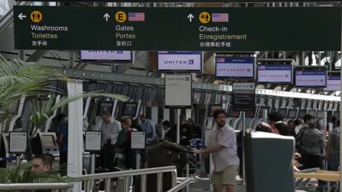 Man Points and Moves Through Busy Airport Terminal Video stock 219195139