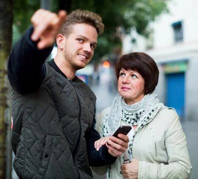 Man points the direction with smartphone Stock-Fotos