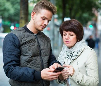 Man points the direction with smartphone Stock Photos