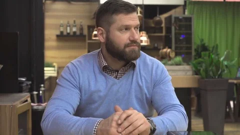 Man points the finger at camera, in pub, cafe, indoor, steadicam shot Vídeo Stock 73067535