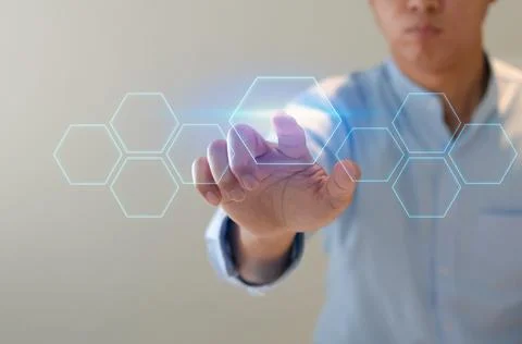 Man points to a futuristic interface. On a virtual screen, a businessman pres Foto stock