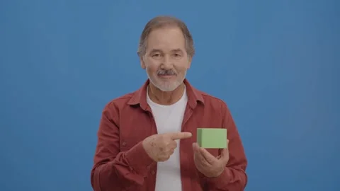 The man points to the green box in his hand with his finger Stock Footage 148594562
