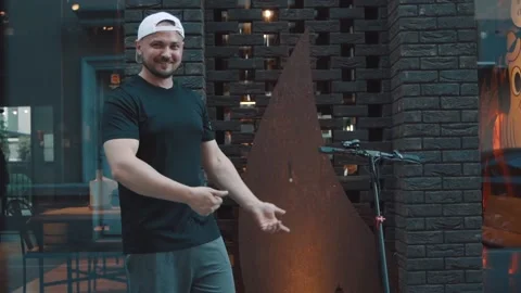 The man points with his hands to the scooter. Emotions. Slow motion Video stock 229257942