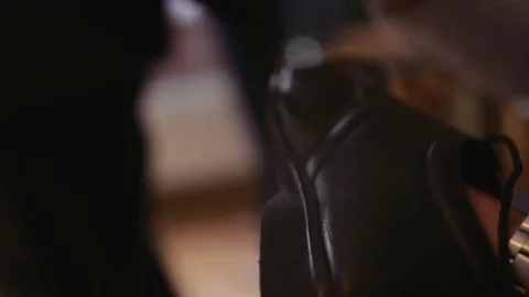 Man polishes a black shoe using a brush to give the fine leather a nice shine Video stock 69976713