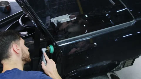 Man polishes surface of part applying tool to surface Stock Footage 317636392