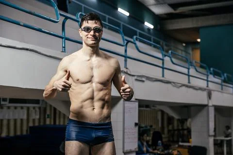 The man in the pool points his thumb up. Concept of sports Stock Photos