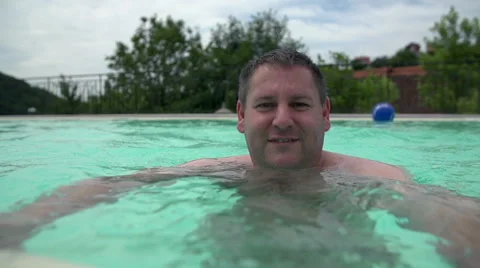 Man in a pool smile to the camera Stock Footage 40714790