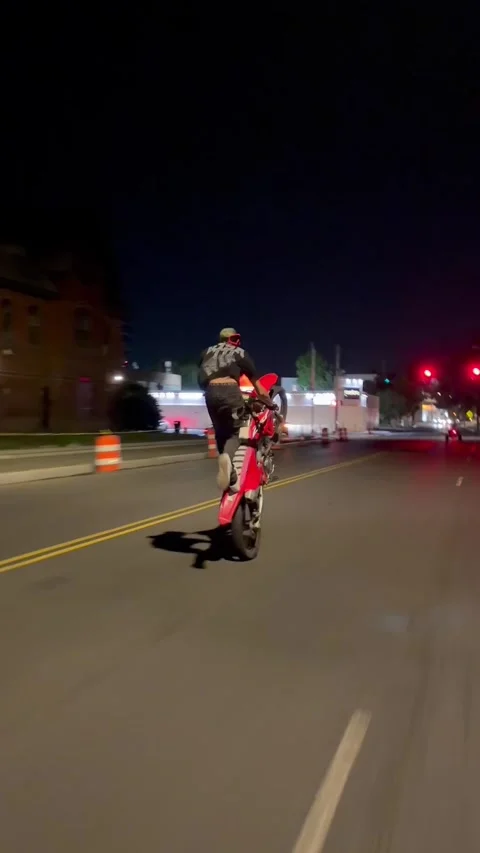 Man Popping Wheely Through a Red Light Almost Gets Hit, usa - 15 Sep 2026 Stock-Footage 345755902